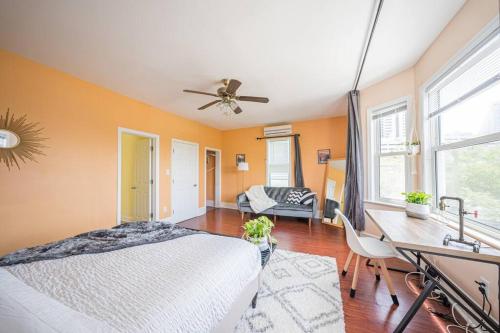 a bedroom with a bed and a desk with a ceiling fan at 7BR 7BA Big House 1 block from Tropicana and Beach in Atlantic City