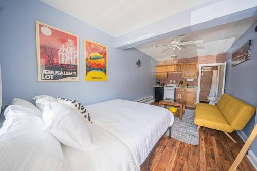 a bedroom with a white bed and a yellow chair at 7BR 7BA Big House 1 block from Tropicana and Beach in Atlantic City