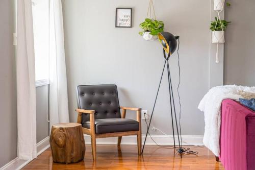 a black chair sitting in a room next to a lamp at 7BR 7BA Big House 1 block from Tropicana and Beach in Atlantic City