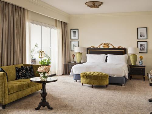 a hotel room with a bed and a couch at Miraflores Park, A Belmond Hotel, Lima in Lima