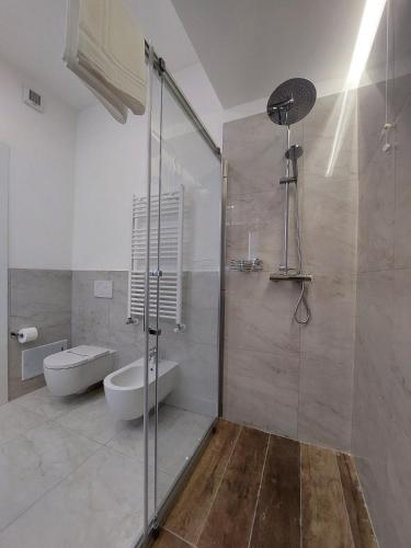 a bathroom with a glass shower and a toilet at Dimora Gentile Lecce B&B in Lecce