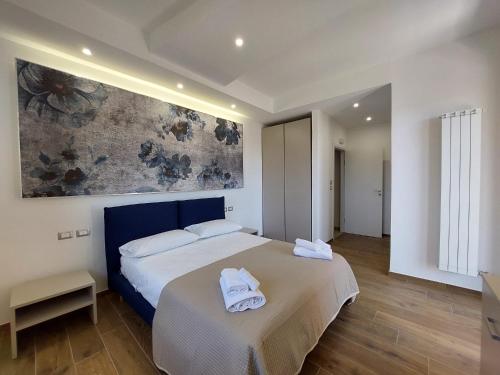 a bedroom with a bed with two towels on it at Dimora Gentile Lecce B&B in Lecce