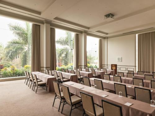 a conference room with tables and chairs andwindows at Miraflores Park, A Belmond Hotel, Lima in Lima