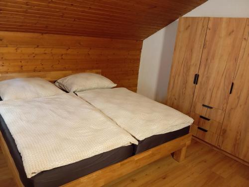 a bedroom with a bed in a wooden room at Ferienwohnung Maier in Mittersill