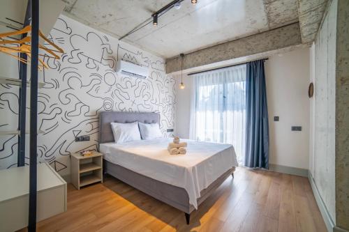Postel nebo postele na pokoji v ubytování RudBlu Suites