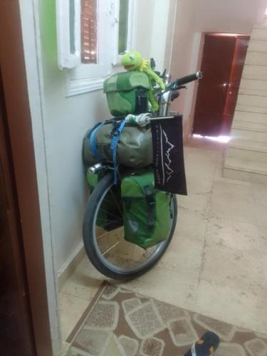 a bike parked next to a wall with bags on it at Nubian Life Nile View in Aswan