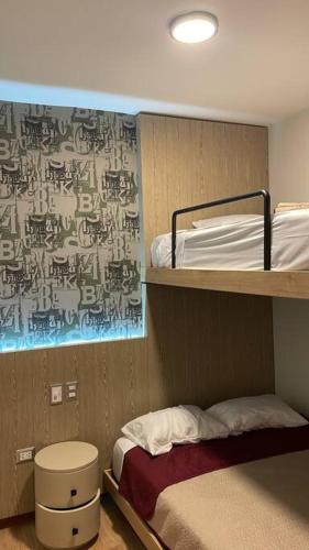 a room with two bunk beds and a bed at Casa Dama in Cieneguilla