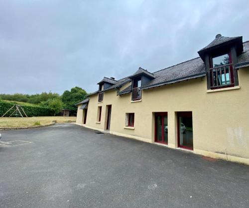 a building with a parking lot in front of it at Petit Launay - proche Rennes in Vezin-le-Coquet