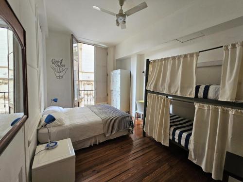 a bedroom with a bed and a window at BA Stop Hotel House in Buenos Aires