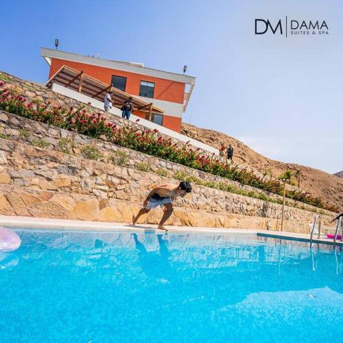 a man standing in a swimming pool with a frisbee at Casa Dama in Cieneguilla