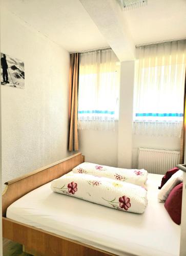 a bed with two pillows on it in a bedroom at Alpenresorts Landeck in Landeck