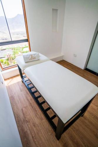 a bed in a room with a large window at Casa Dama in Cieneguilla