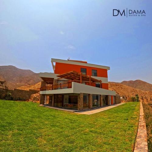 a large house on top of a grassy field at Casa Dama in Cieneguilla
