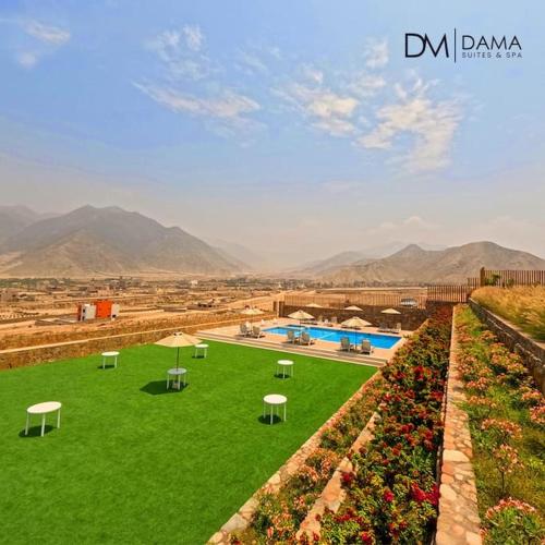 a green yard with tables and a swimming pool at Casa Dama in Cieneguilla