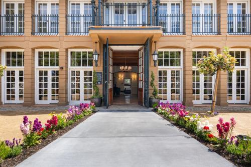 a walkway leading to a building with flowers at Private Guest Suite in the Heart of Santa Rosa! in Santa Rosa