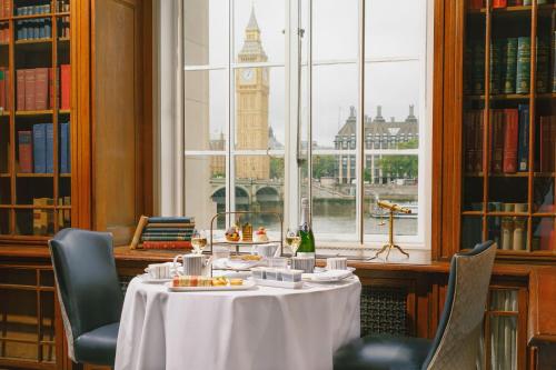 a table in a library with a view of big ben at London Marriott Hotel County Hall in London
