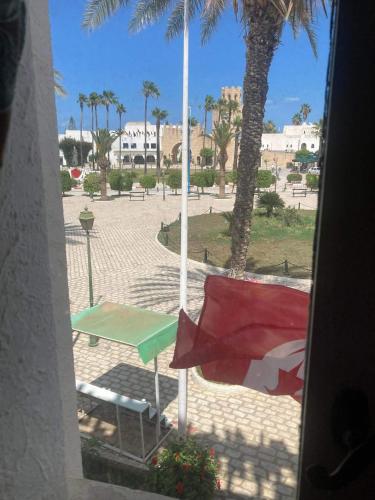 a view from a window of a park with palm trees at Sousse Marina Kantaoui l'expérience côtière in Port El Kantaoui