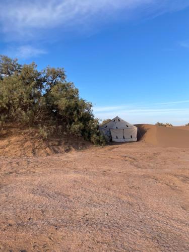a barn in the middle of the desert at Riad Al-Badouin in Mhamid