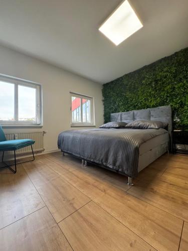 a bedroom with a bed with a green wall at Apartment in zentraler Lage No 3 in Rostock