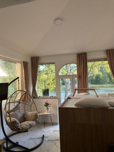 a bedroom with a large bed and a large window at Oaza mira in Gornja Trešnjica