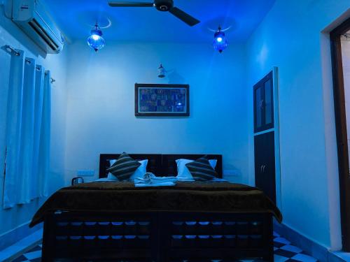a blue bedroom with a bed with blue walls at Hotel Renuka in Jaisalmer