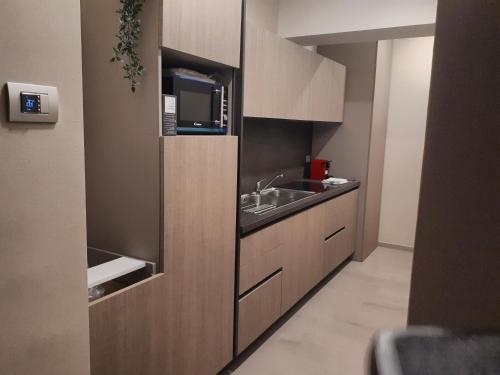 eine Küche mit Spüle und Mikrowelle in der Unterkunft Smart Apartment Sei Chiese - TWA in Bologna