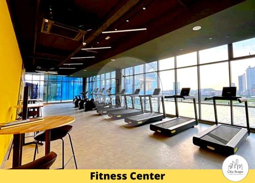 a fitness center with a bunch of treadmills at Setia Alam Sunsuria Forum Soho Suites by Cityscape in Setia Alam