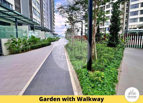 a garden with walkway in a city with buildings at Setia Alam Sunsuria Forum Soho Suites by Cityscape in Setia Alam