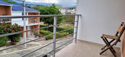 a chair sitting on a balcony with a view at Acogedora y amplia casa en Anapoima con piscina en condominio cerrado - hasta 8 personas in Anapoima