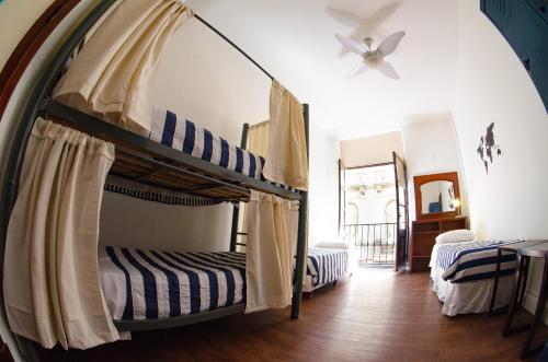 two bunk beds in a room with a ceiling fan at BA Stop Hotel House in Buenos Aires