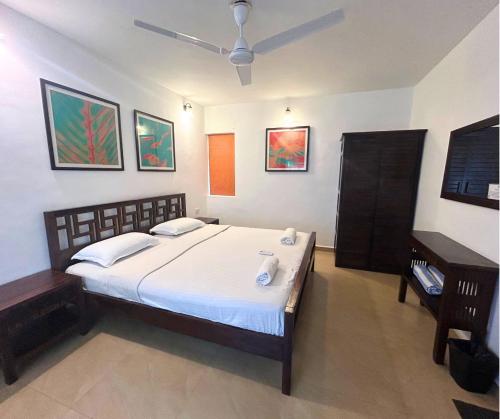 a bedroom with a large bed in a room at Jungle Hut-Annabelle's Beach Apartments at Bernard Simao,Calangute,Goa in Candolim