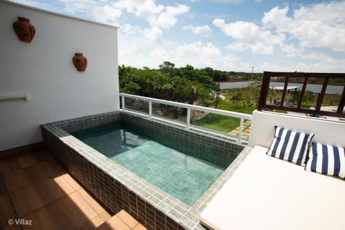 a swimming pool on the balcony of a house at Villaz Lençóis Maranhenses in Santo Amaro