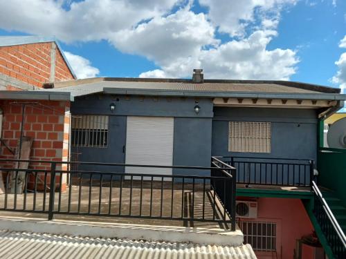 a blue building with a balcony in front of it at RoMalandya in Villa Dolores