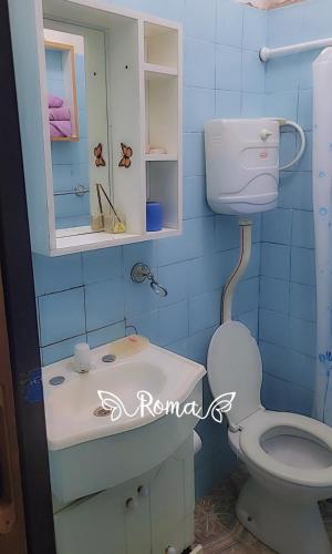 a bathroom with a toilet and a sink and a mirror at RoMalandya in Villa Dolores