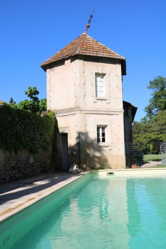 un immeuble avec une piscine devant un immeuble dans l'établissement Mas Provencal Monteux 84170, à Althen-des-Paluds
