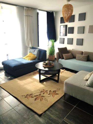 a living room with a couch and a table at Très Beau Logement en centre ville in Beaugency