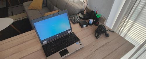 a laptop computer sitting on top of a wooden floor at Студио Нико - Царево in Tsarevo