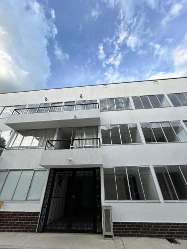 a large white building with a revolving door at Horeb Paradise in La Tebaida