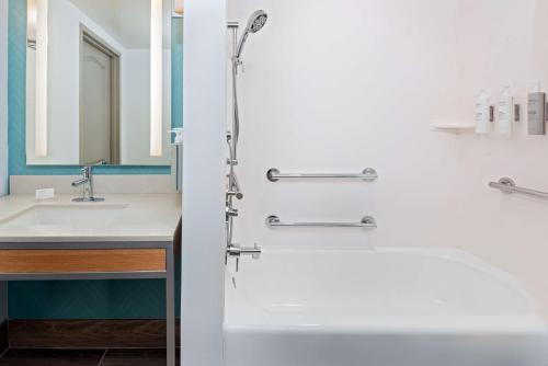 a bathroom with a shower and a sink at Hilton Garden Inn Orlando International Drive North in Orlando
