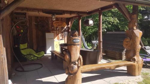 a wooden pergola with a swing in a yard at Lonni Nature Eco-Accommodation in Hagudi