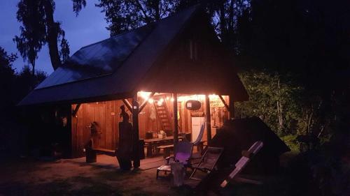 a man standing in front of a tent at night at Lonni Nature Eco-Accommodation in Hagudi
