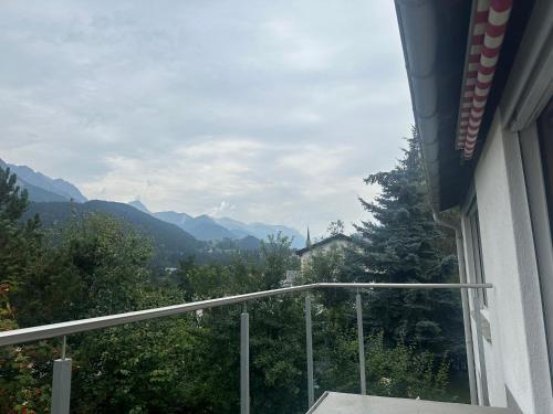 a balcony with a view of the mountains at Chasa Stefania, modernes Engadiner Haus mit Wellness und Sauna in Scuol