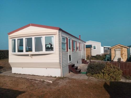 a tiny house with a window on the side of it at Mobil Home Front de mer in Portbail