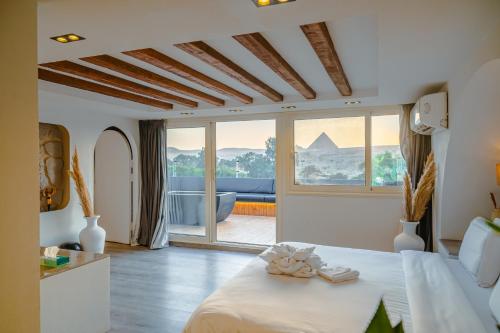 a bedroom with a bed and a large window at Great Pyramid Inn in Cairo