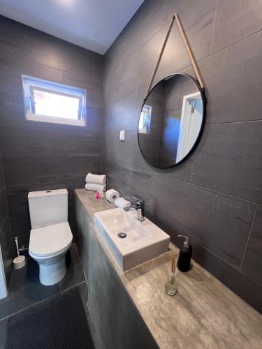 a bathroom with a white sink and a mirror at Casa Lourenço in Silves