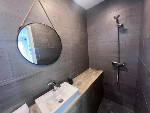 a bathroom with a sink and a mirror at Casa Lourenço in Silves