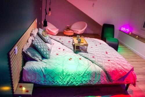 une chambre avec un grand lit dans une pièce dans l'établissement La romance champêtre, à La Noë-Blanche