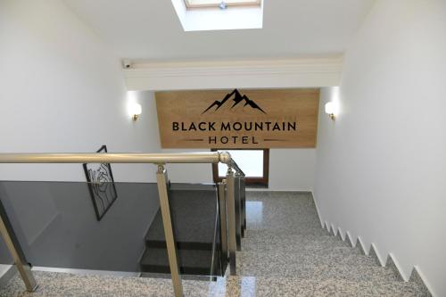 a hallway with a sign that reads black mountain hotel at BlackMountain Hotel in Kolgecaj