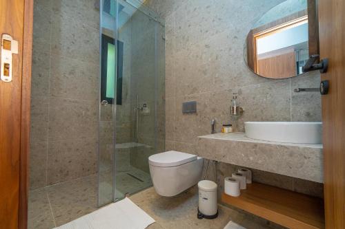 a bathroom with a toilet and a sink and a shower at Villa vue atlas marrakech in Marrakech