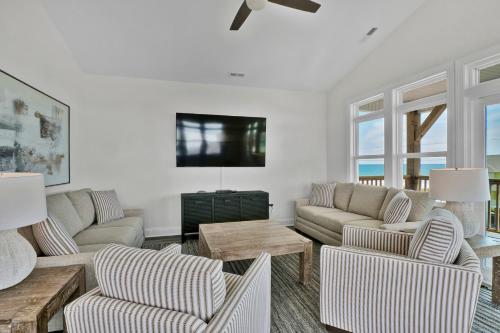 een woonkamer met twee banken en een tv bij Beachside Bliss by Sea Scape Properties in North Topsail Beach